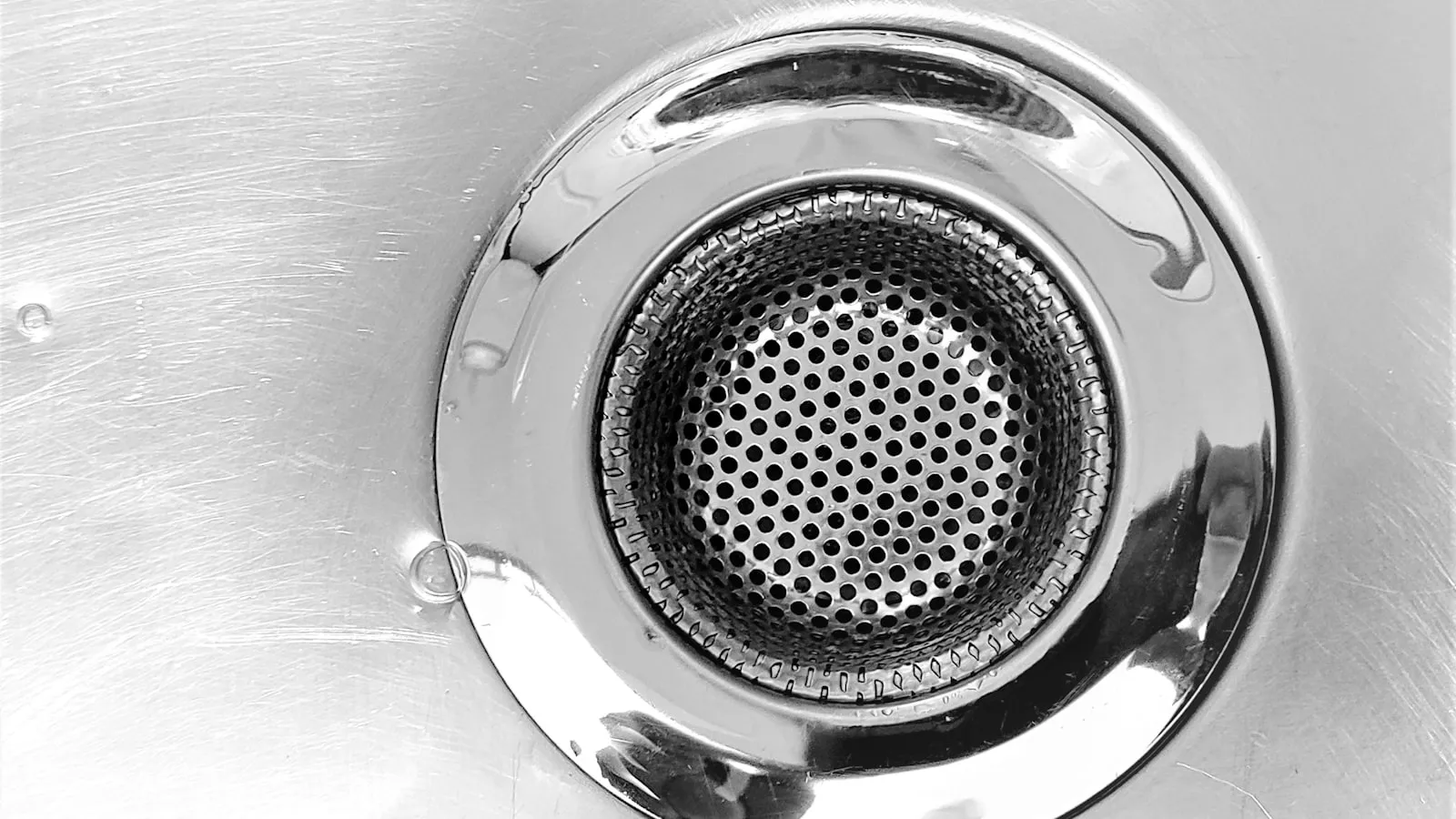 Close-up of a stainless steel kitchen sink drain